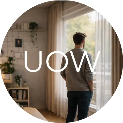 Circular logo showing the letters UOW over a calm home workspace background